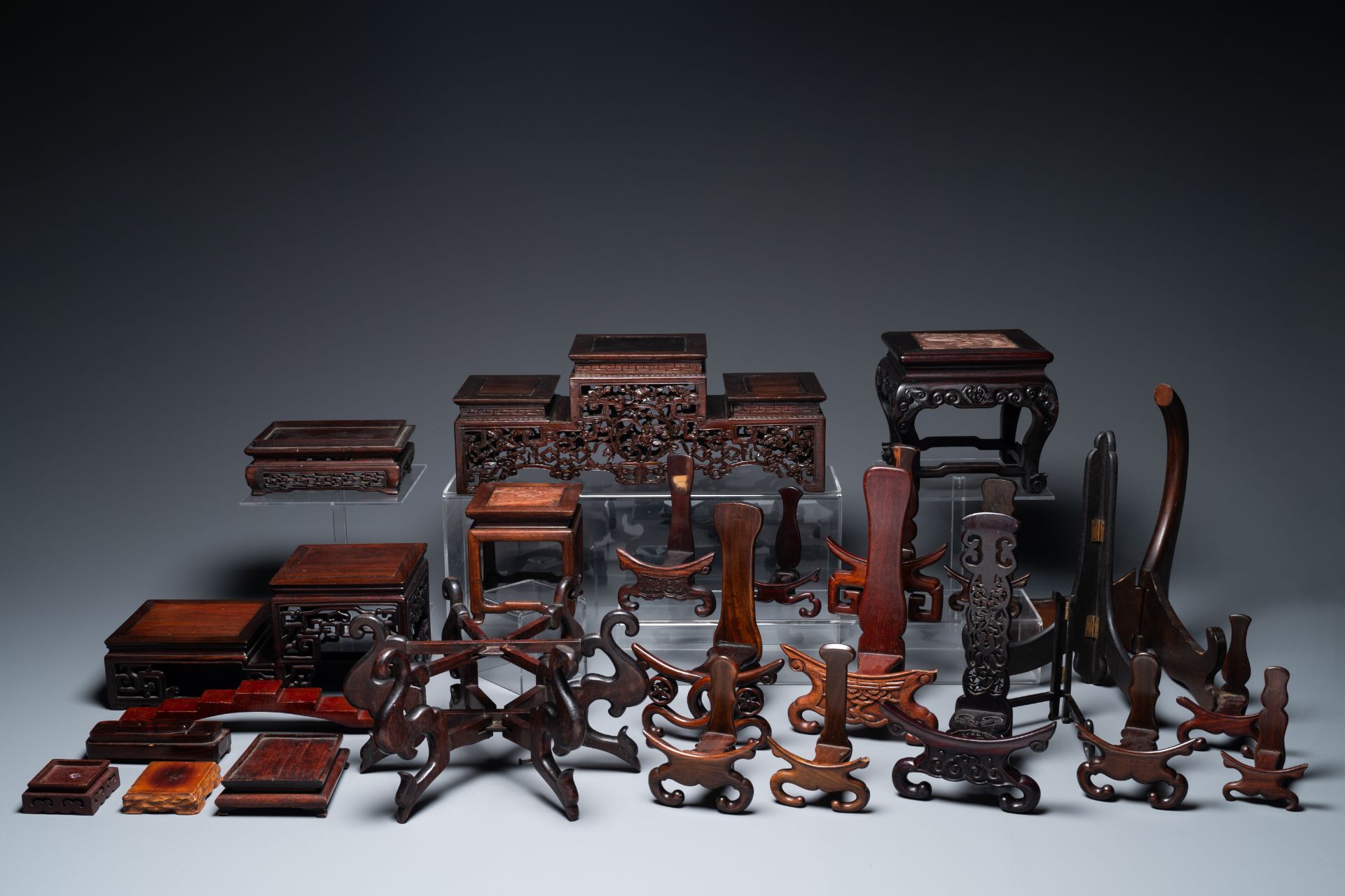 A collection of 26 varied Chinese wooden stands, 2 with marble tops, 19/20th C.