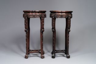 A pair of tall Chinese carved wooden stands with marble tops, 19th C.