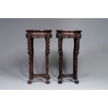 A pair of tall Chinese carved wooden stands with marble tops, 19th C.