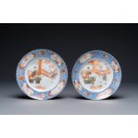A pair of Chinese Imari-style plates with a merchant, lady and boy, Kangxi