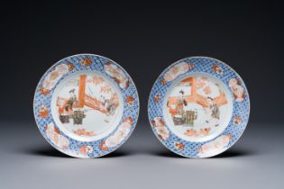 A pair of Chinese Imari-style plates with a merchant, lady and boy, Kangxi
