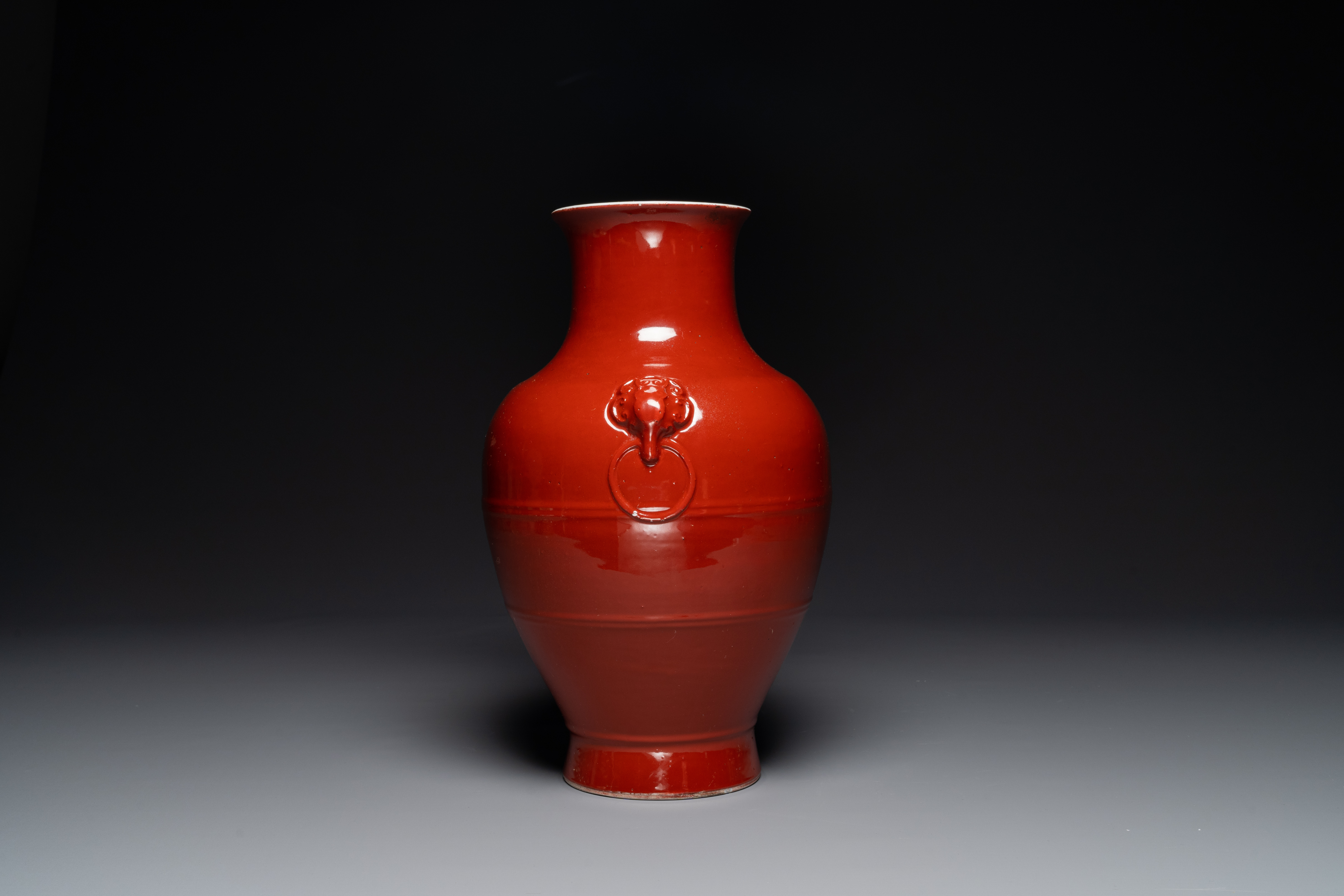 A Chinese monochrome red-glazed 'hu' vase, Qianlong mark, 19th C. - Image 4 of 6