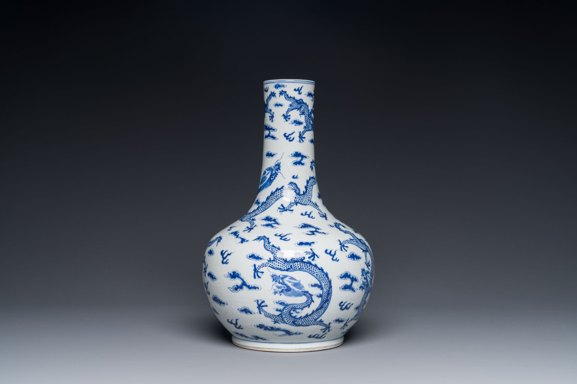 A Chinese blue and white bottle vase with dragons among flames and clouds, 19th C. - Image 2 of 3