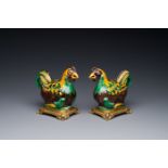 A pair of Chinese sancai-glazed chicken ewers mounted as candleholders with gilt bronze, Kangxi