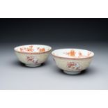 A pair of Chinese iron-red-decorated and gilt bowls with relief design, Kangxi