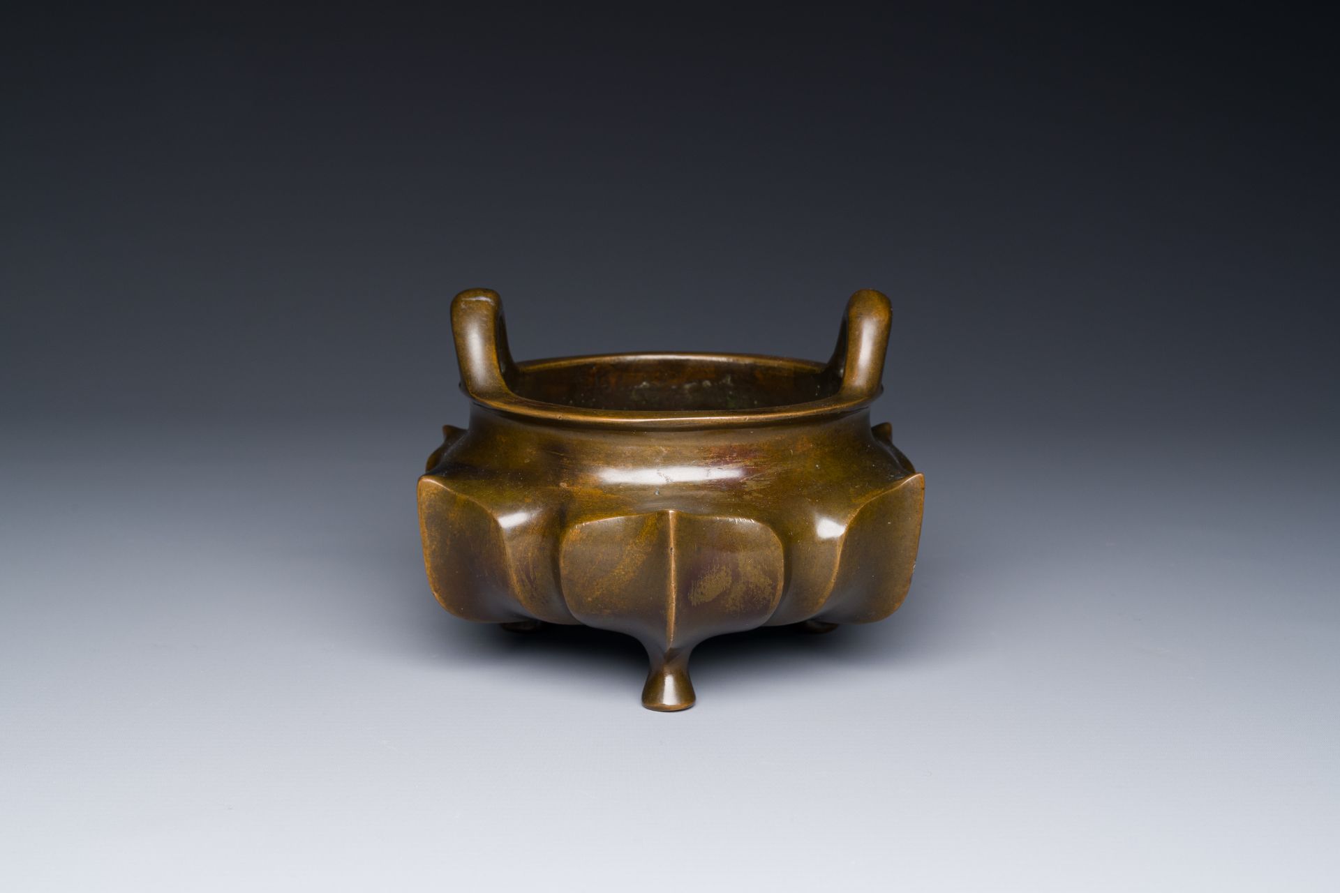 A Chinese bronze lotus-shaped tripod censer, Xuande mark, 18/19th C.