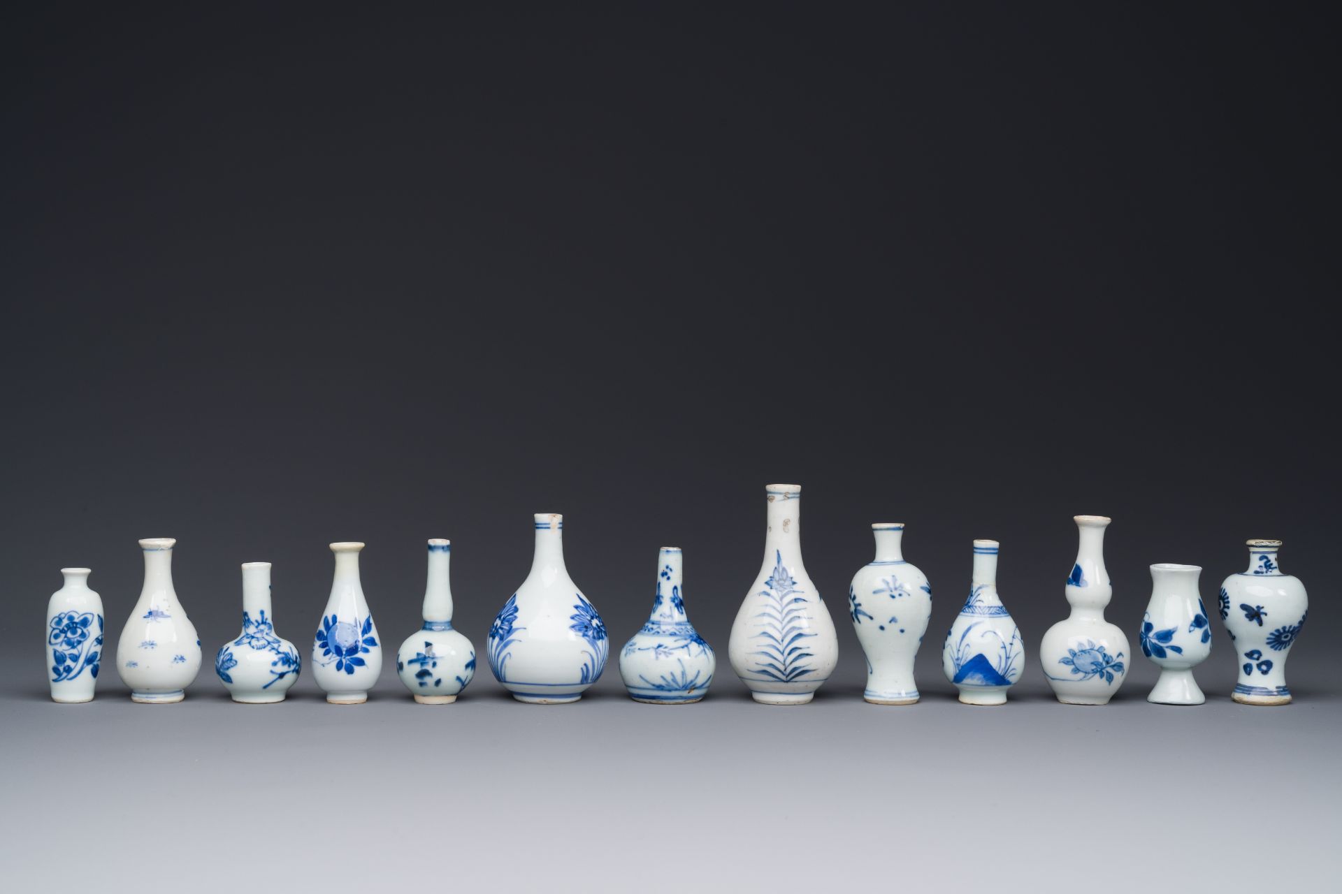 Thirteen Chinese blue and white miniature vases with floral design, Kangxi - Image 4 of 5