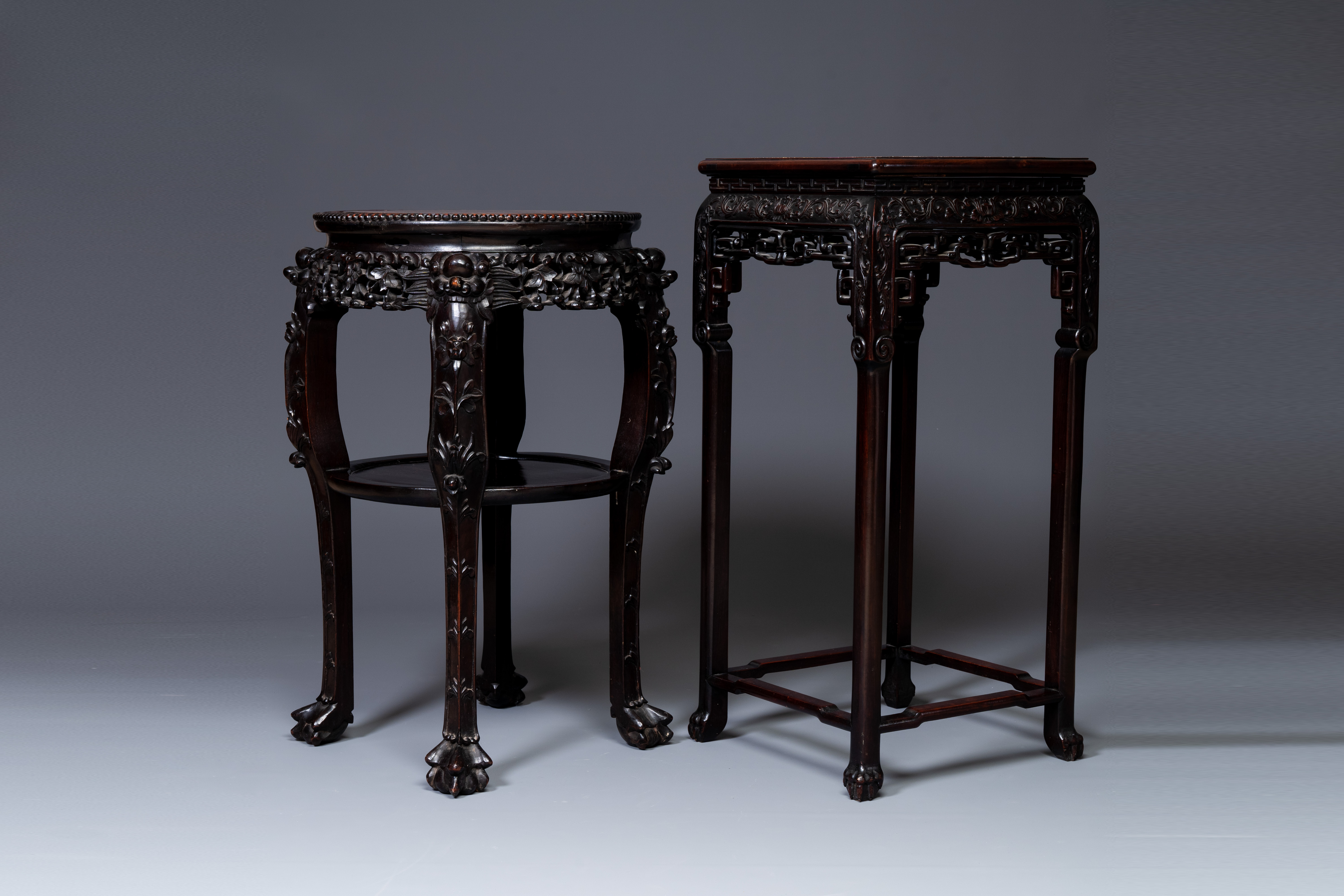 Two Chinese carved wooden stands with marble tops, 19th C.