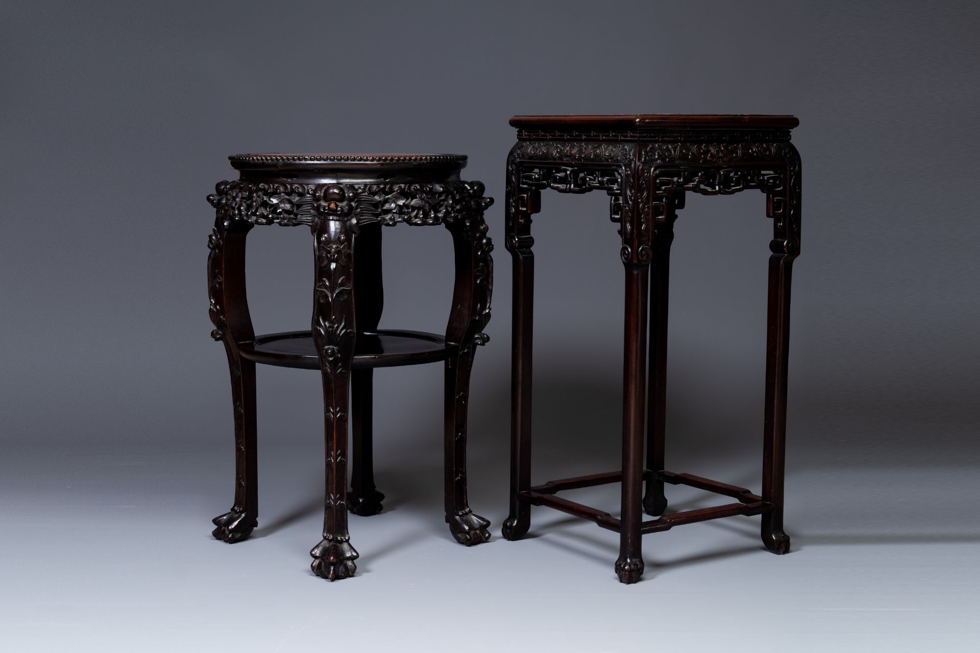 Two Chinese carved wooden stands with marble tops, 19th C.