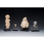 Two small Gandhara grey schist Bodhisattva heads, a stucco sculpture of Bodhisattva and a stucco fem