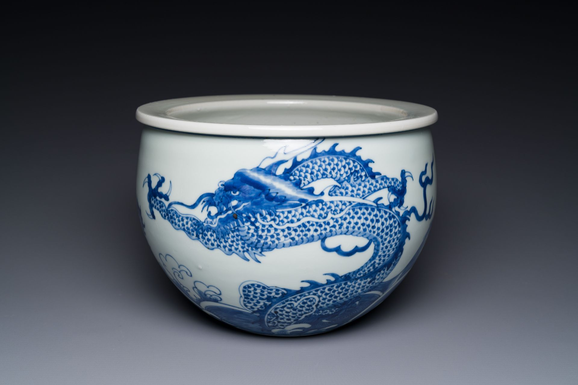 A Chinese blue and white 'dragons and carps' jardiniere, 19th C.