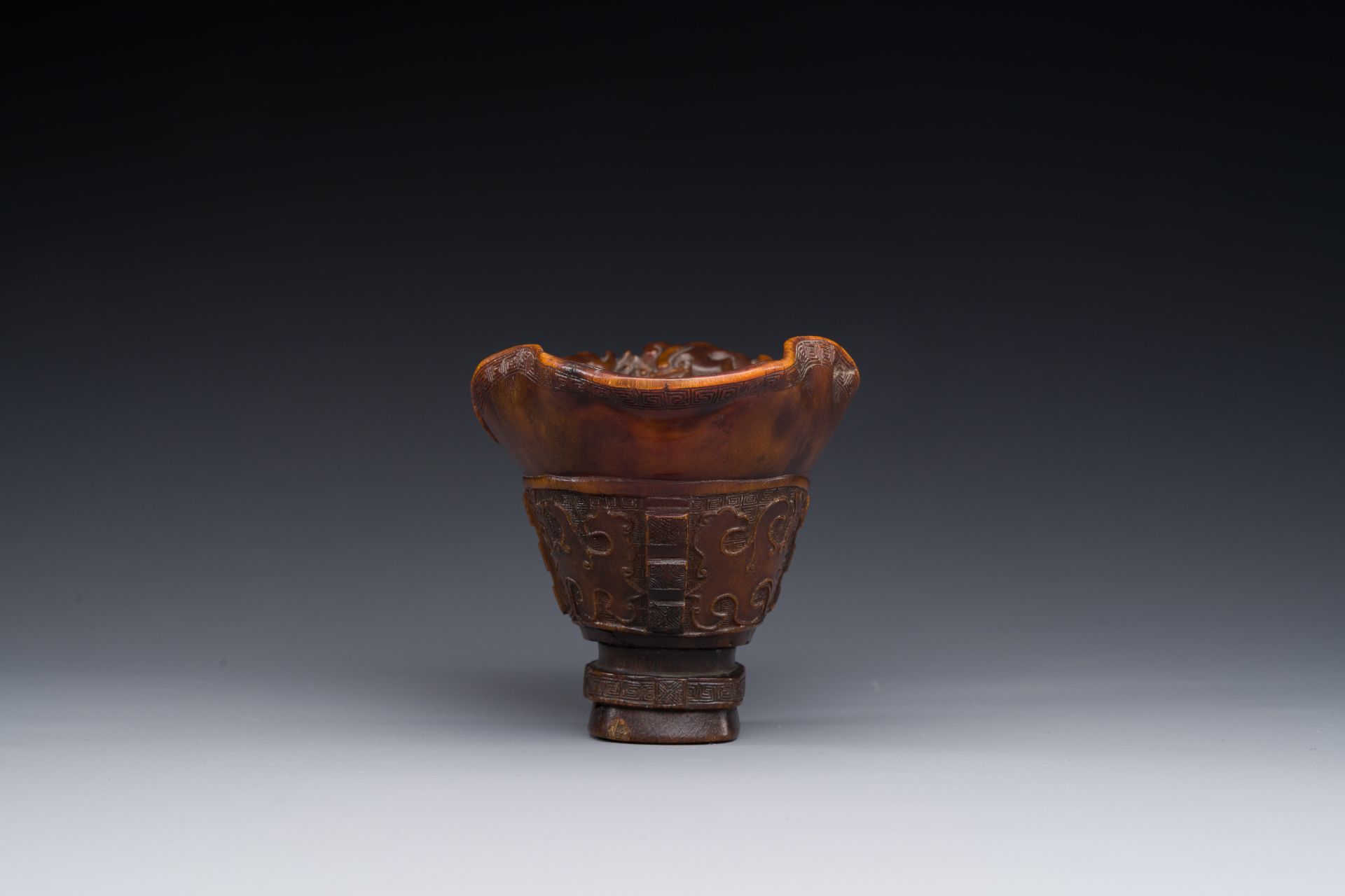 A Chinese carved rhinoceros horn 'libation cup' with chilong design, 17/18th C. - Image 6 of 8
