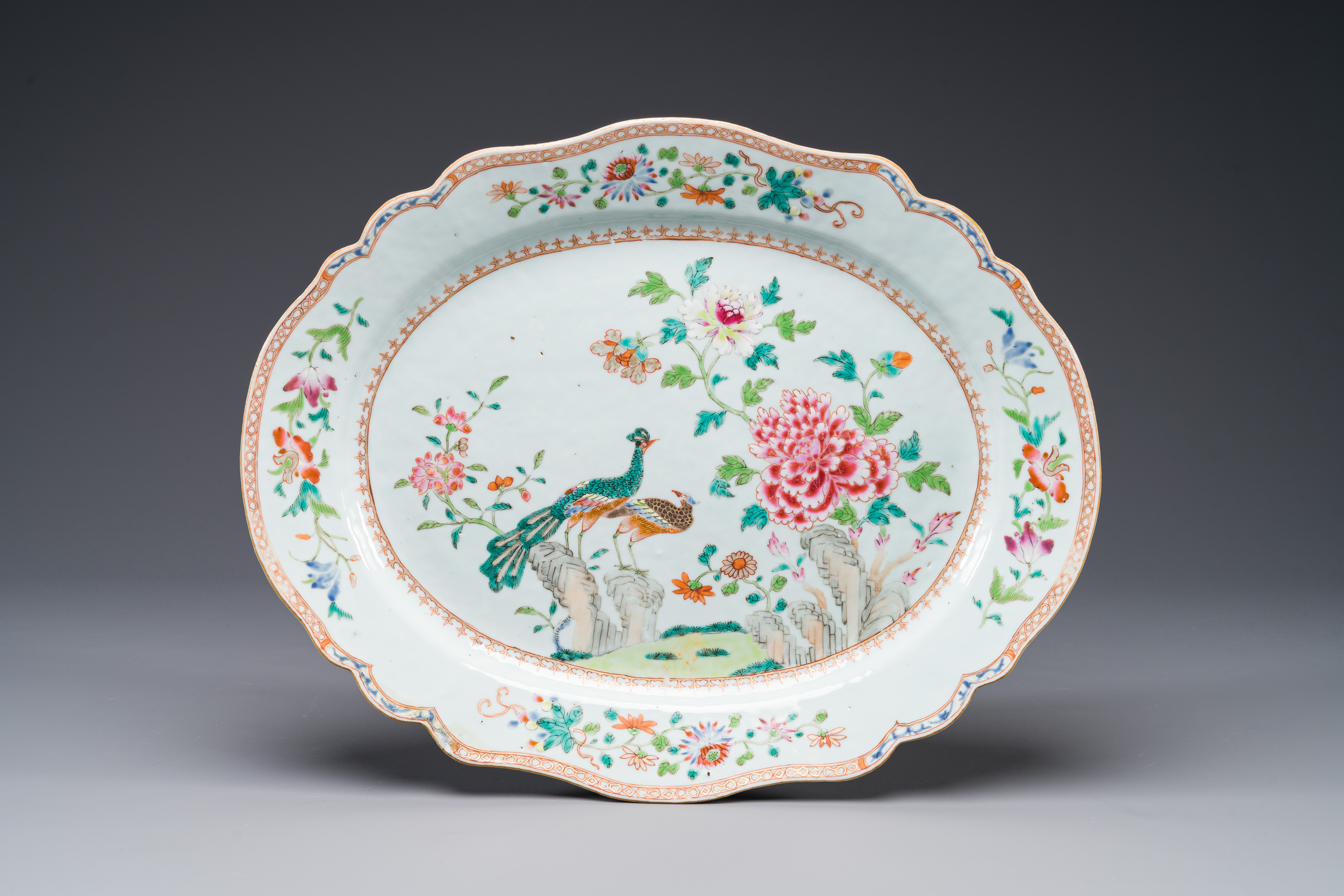 An oval Chinese famille rose dish with birds near blossom branches, Qianlong
