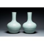 A pair of large Chinese monochrome celadon-glazed anhua 'lotus scrol' bottle vases, 19th C.