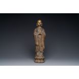 A Chinese gilt cast iron figure of a standing monk, Ming