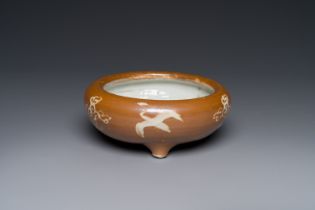 A rare Chinese Swatow slip-decorated brown-glazed tripod censer with cranes, Ming