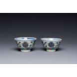 A pair of Chinese doucai 'lotus scroll' cups, Guangxu mark and of the period