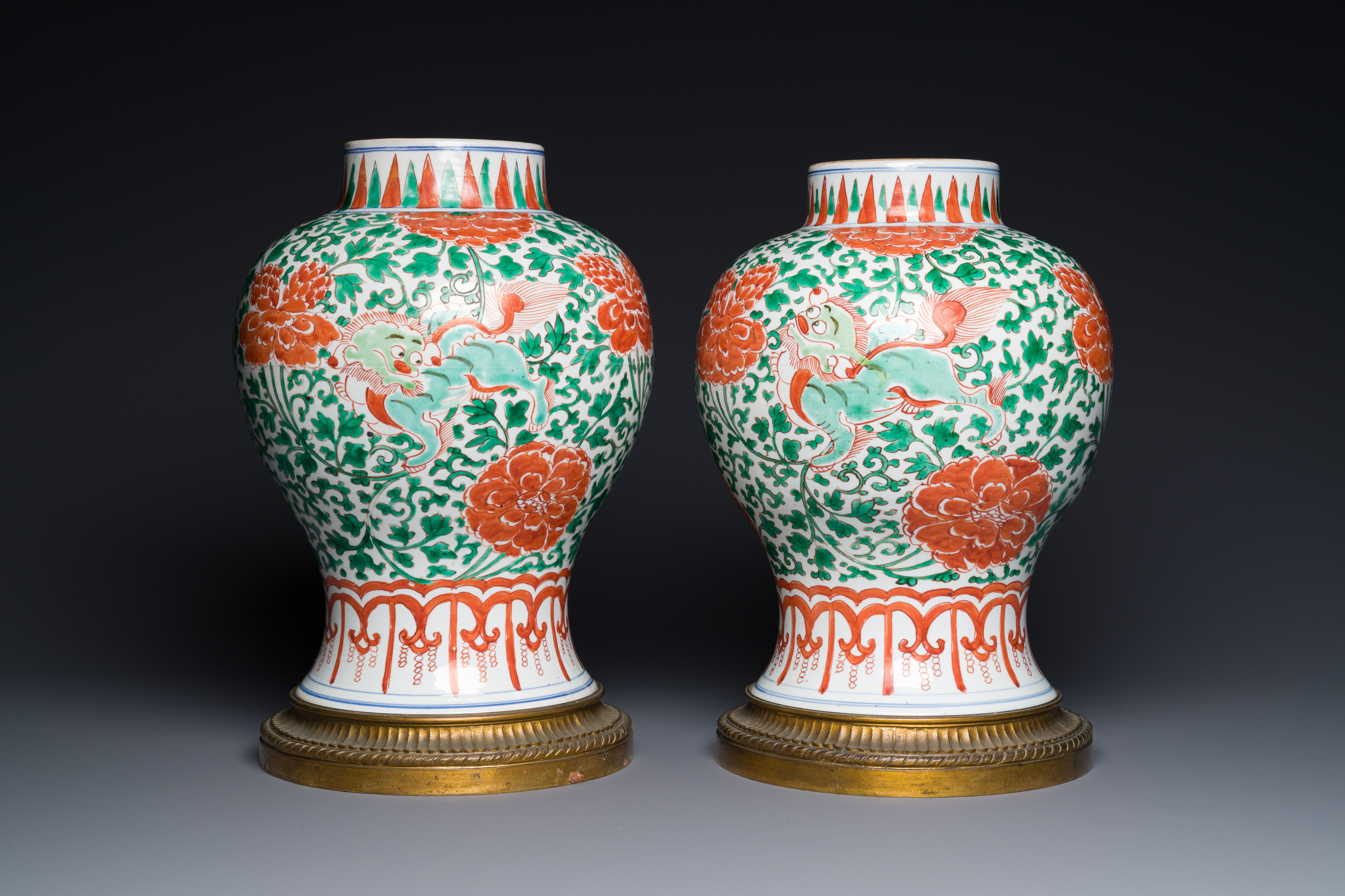 A pair of Chinese famille verte 'Buddhist lion' vases with gilt bronze mounts, Kangxi