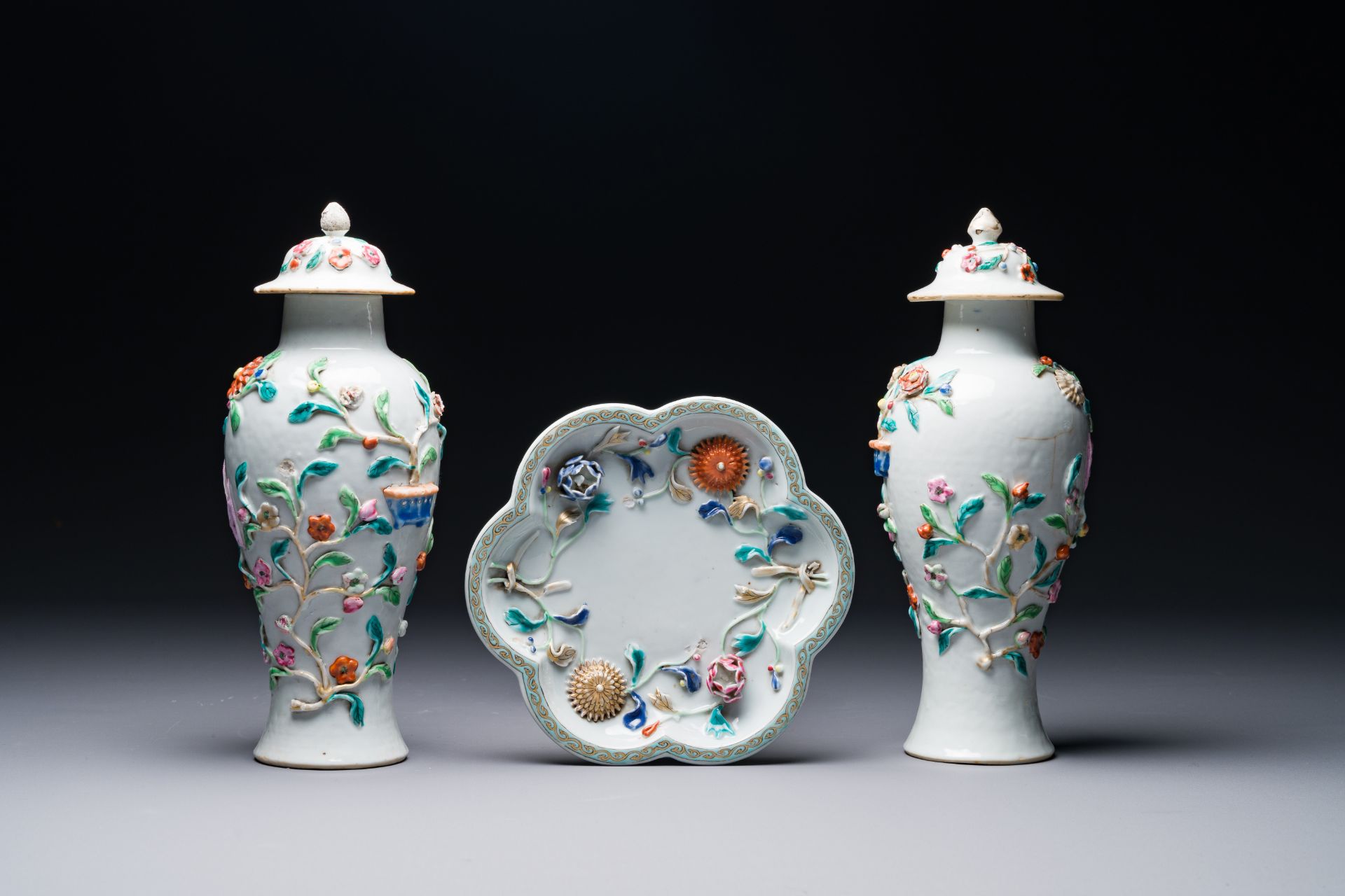 A pair of Chinese famille rose covered vases and a plate with applied floral design, Yongzheng