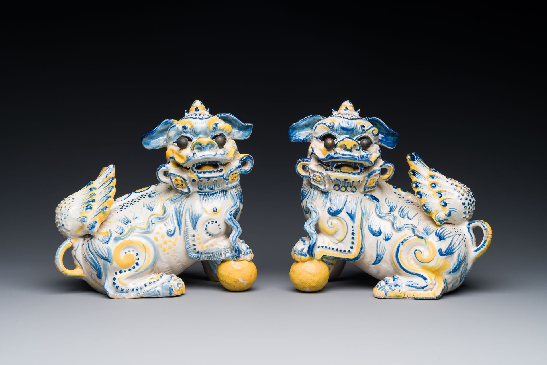 A pair of Portuguese polychrome faience sculptures of lions, 17/18th C.