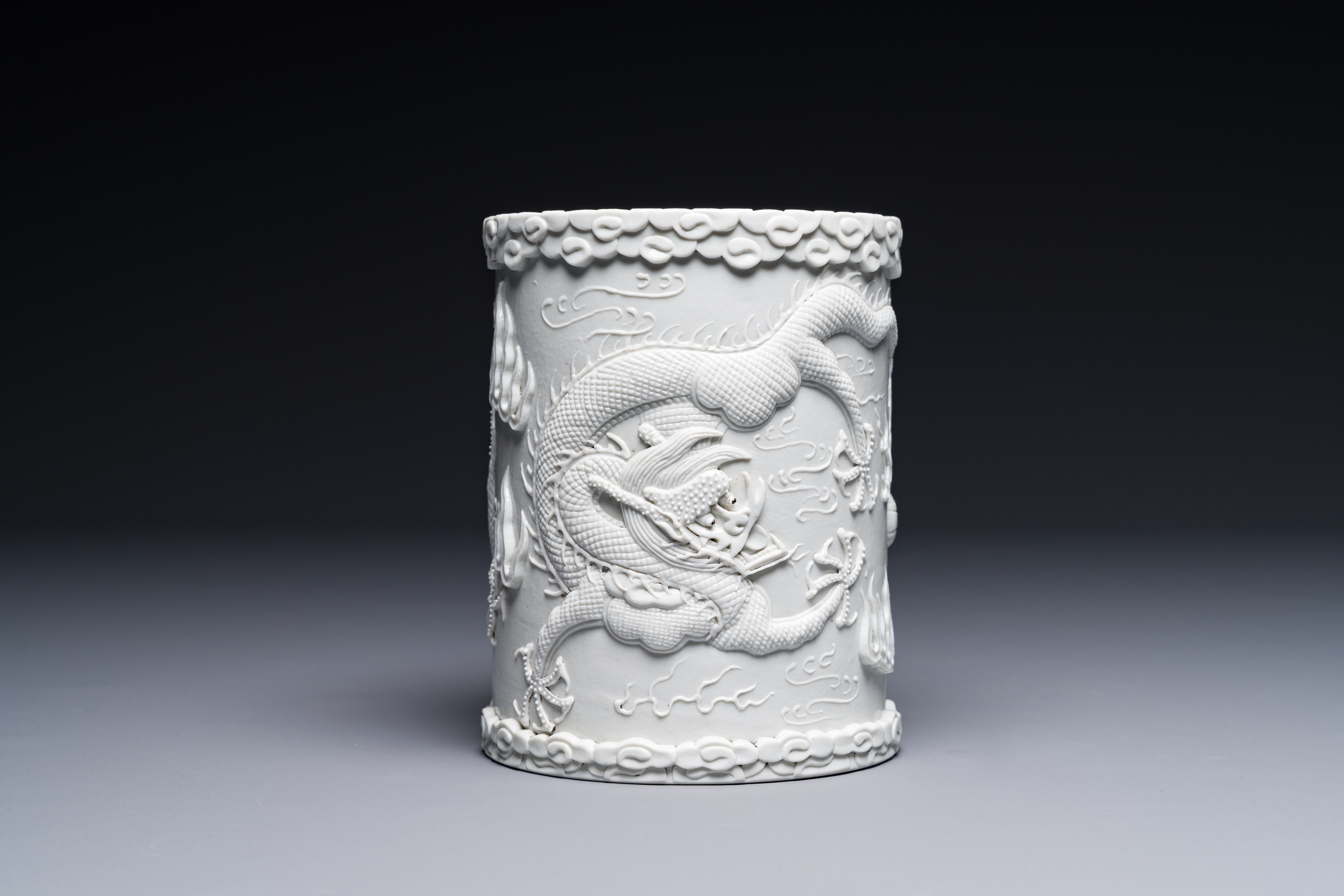 A Chinese monochrome white-glazed biscuit brush pot, signed Wang Bingrong çŽ‹ç‚³æ¦®, 19/20th C.