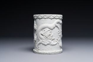 A Chinese monochrome white-glazed biscuit brush pot, signed Wang Bingrong çŽ‹ç‚³æ¦®, 19/20th C.