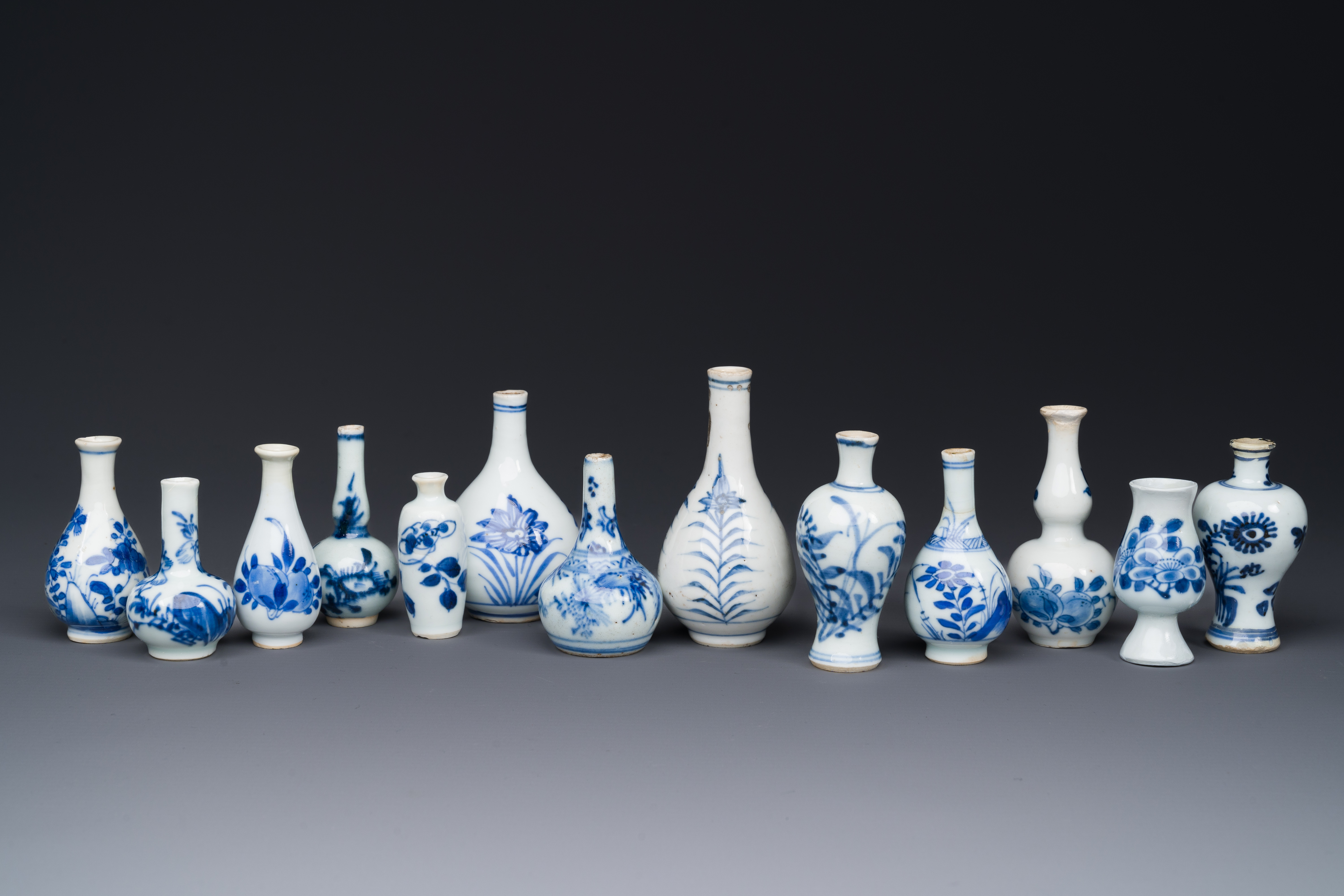 Thirteen Chinese blue and white miniature vases with floral design, Kangxi