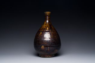 A Korean monochrome brown-glazed bottle vase, Goryeo, 15/16th C.