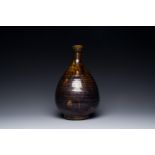 A Korean monochrome brown-glazed bottle vase, Goryeo, 15/16th C.