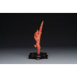 A Chinese red coral figure of a fisherman on wooden stand, 19/20th C.