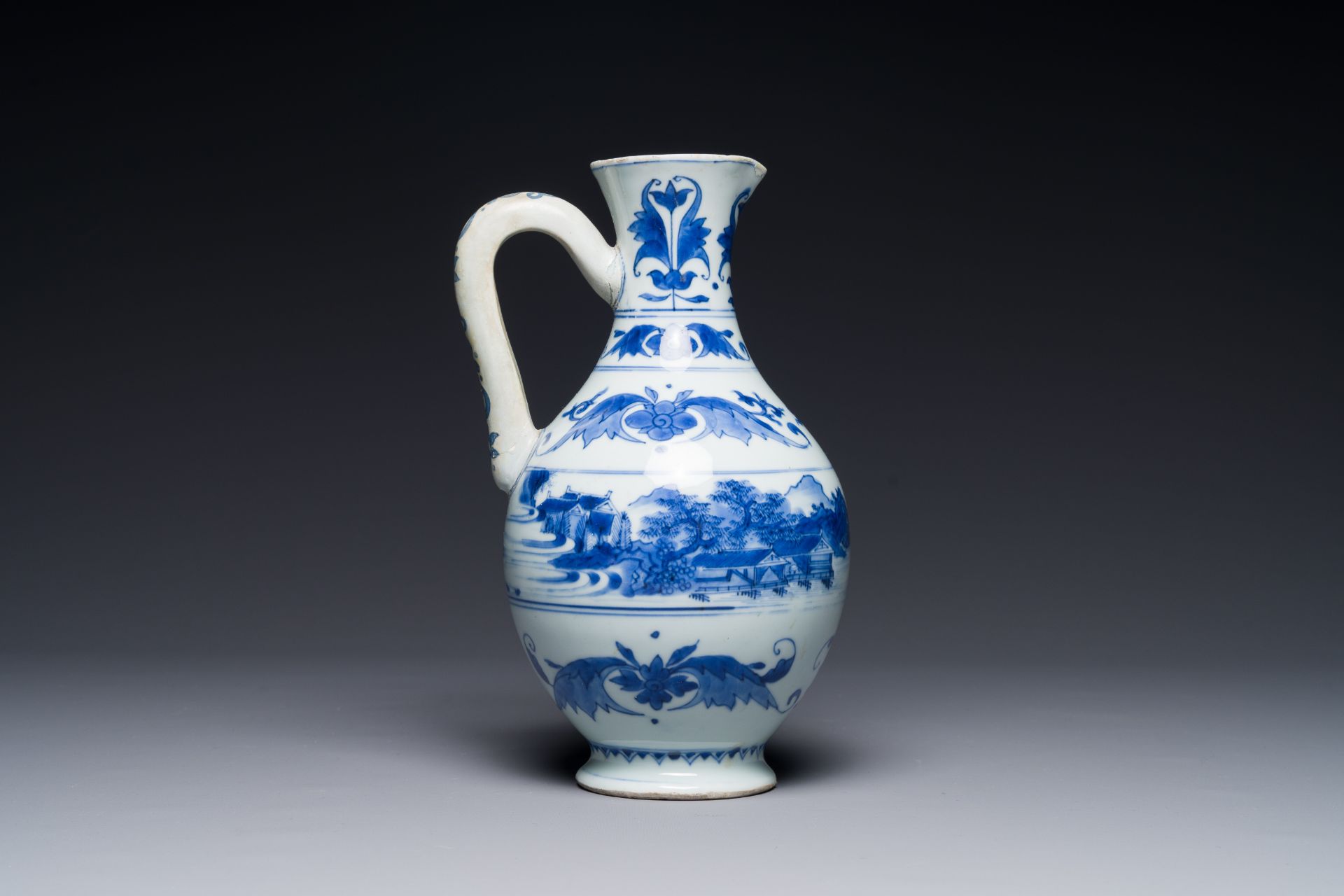 A Chinese blue and white ewer with landscape design, Transitional period