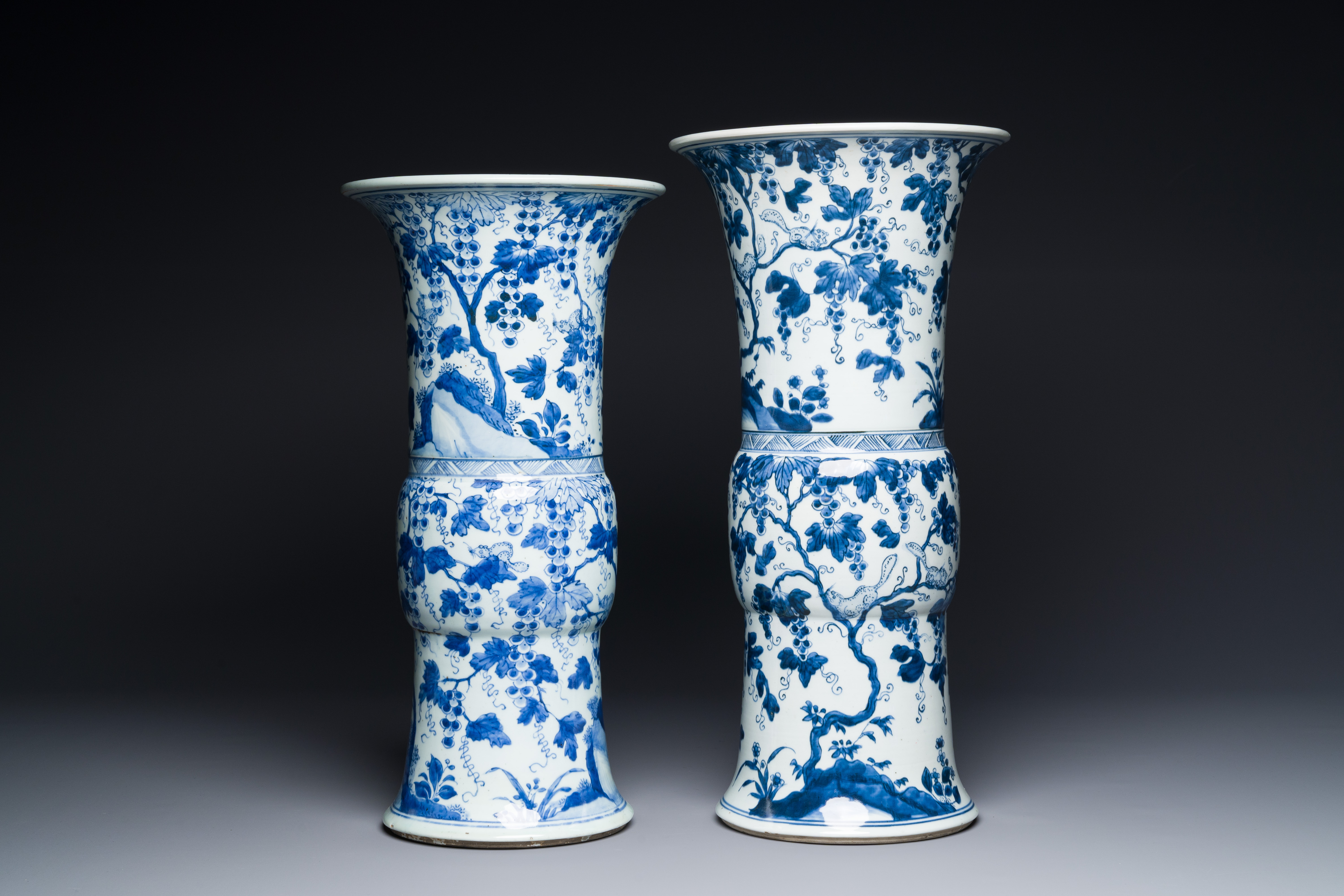 Two Chinese blue and white 'gu' vases with squirrels among grape vines, Kangxi