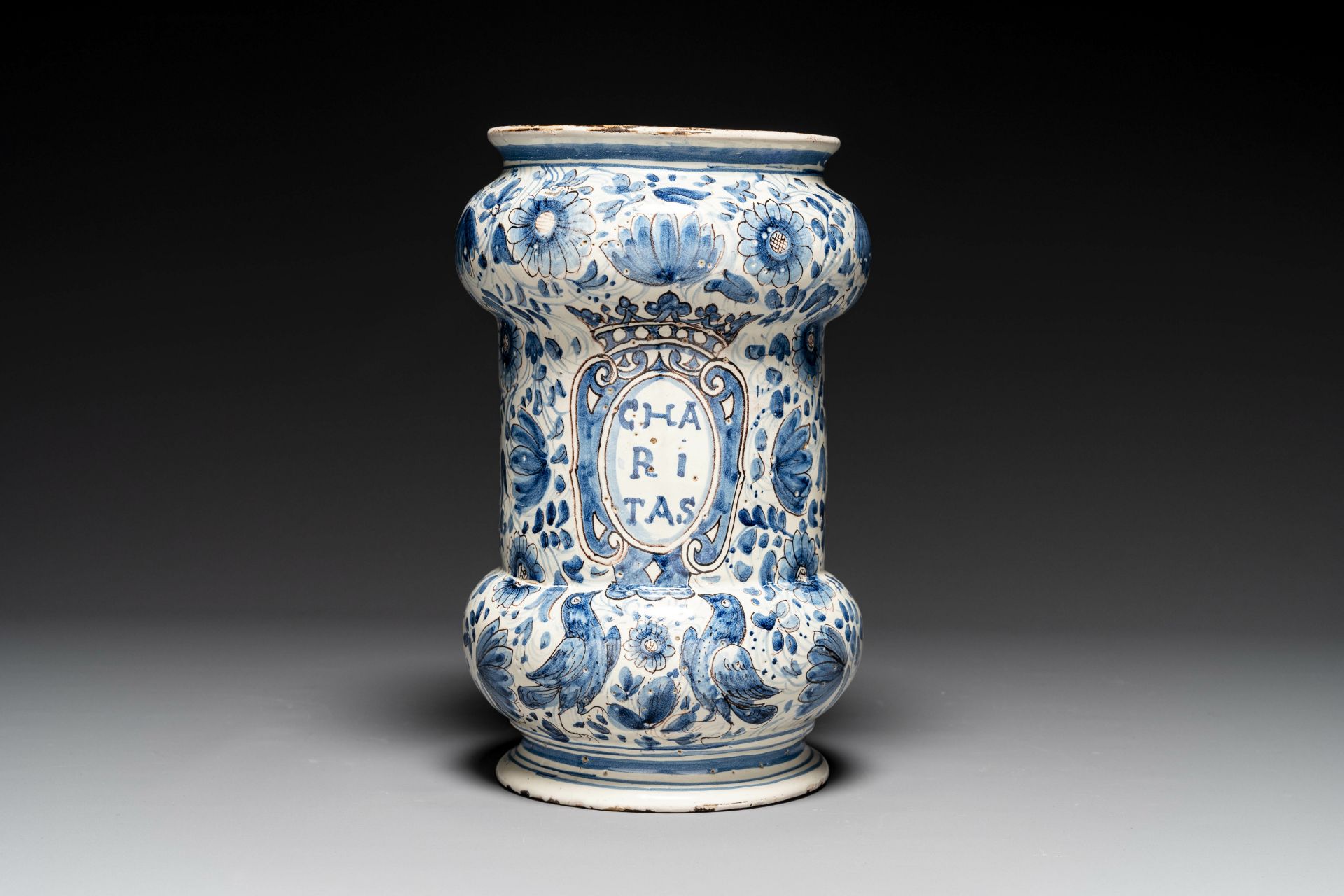 A large Italian blue, white and manganese albarello drug jar inscribed Charitas, probably Savona