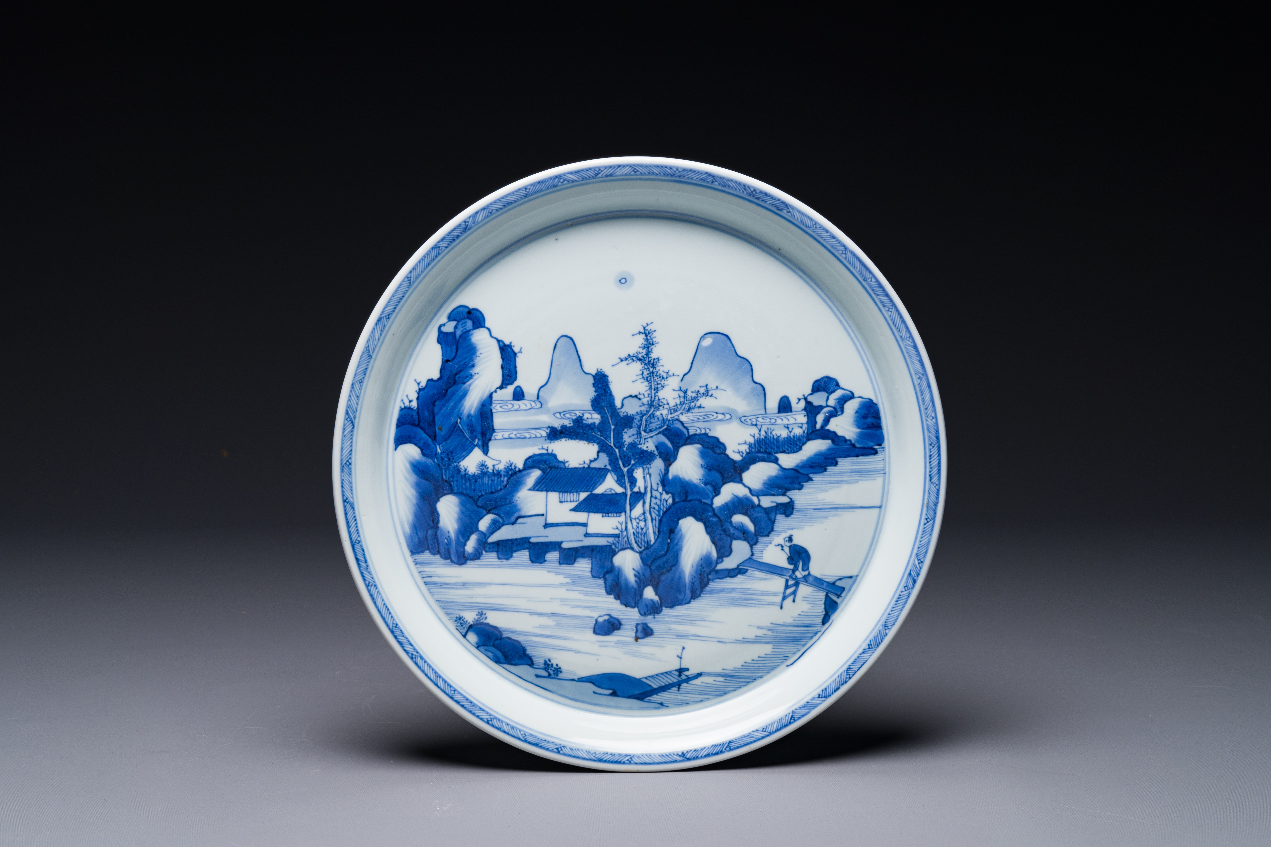 A Chinese blue and white plate with a mountainous river landscape, Chenghua mark, Kangxi