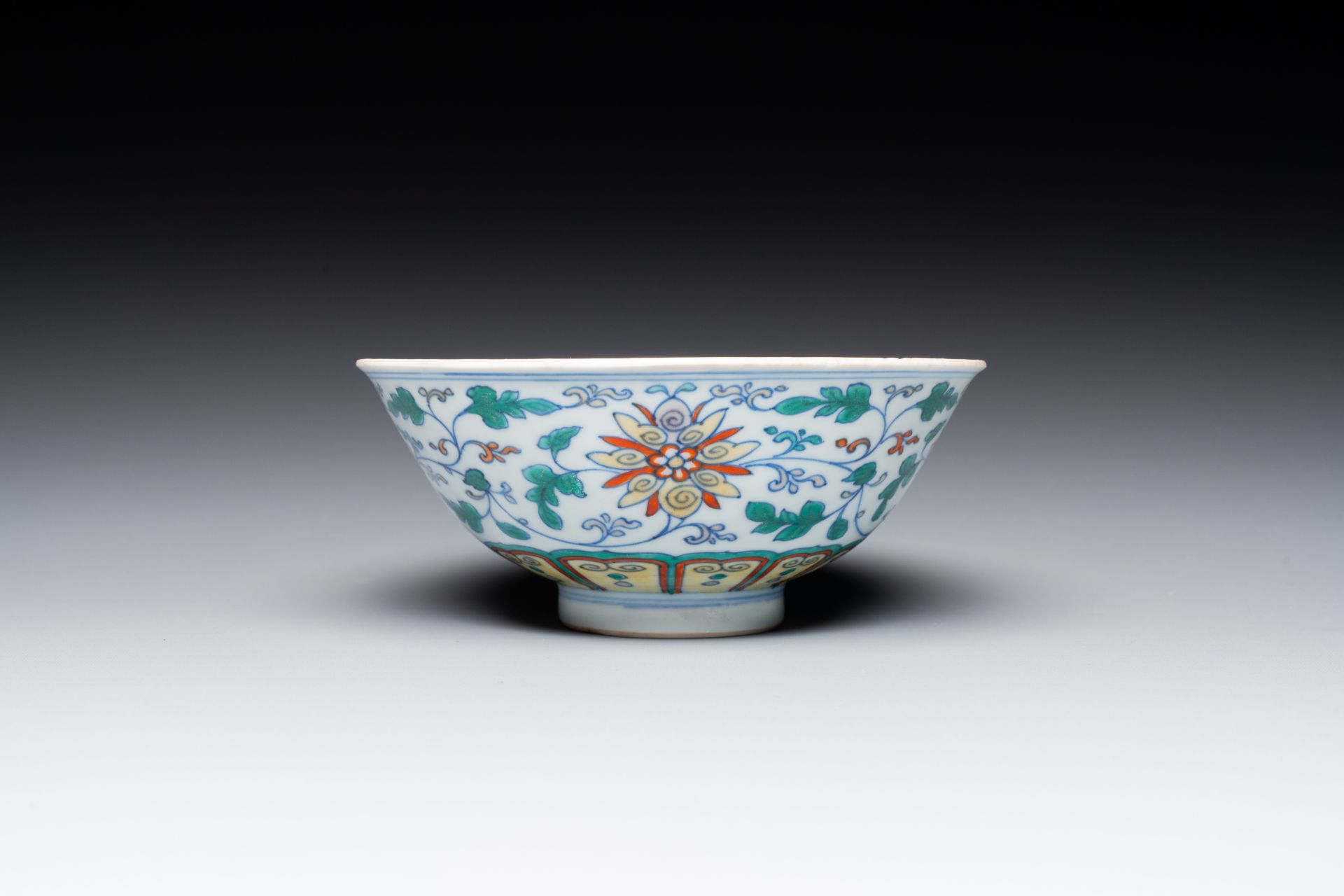 A Chinese doucai 'lotus scroll' bowl, Qianlong mark and of the period - Image 2 of 7