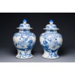 A pair of Chinese blue and white covered vases with figural design, 19th C.