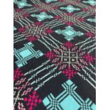 VINTAGE TRADITIONAL WELSH WOOLLEN BLANKET with blue and purple geometric design to a black ground,