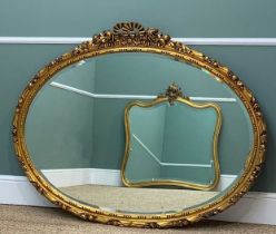 TWO VICTORIAN STYLE GILT MIRRORS, modern, one oval, 110 x 140cms, the other cartouche shaped, 116