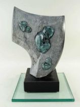 ‡ GLENN MORRIS bronze and carved springstone - 'Fossils' on ebonised plinth and plate glass base,