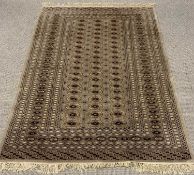 EASTERN STYLE SOFT PILE WOOLEN RUG WITH TASSELED ENDS, muted colour tones, mushroom ground,