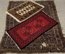 THREE VINTAGE AND LATER EASTERN STYLE WOOLEN RUGS, the largest example has an all-over colourful
