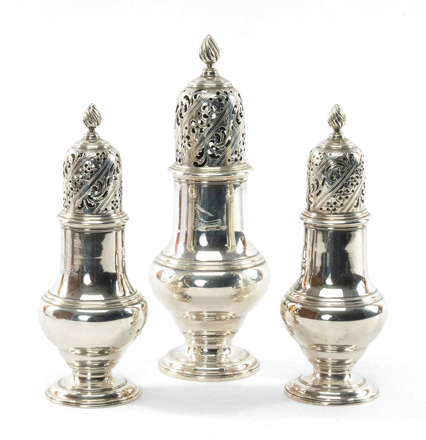 SET OF THREE GEORGE II SILVER CASTERS having pierced lid and spiral knop terminal, circular foot,
