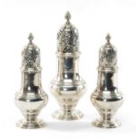 SET OF THREE GEORGE II SILVER CASTERS having pierced lid and spiral knop terminal, circular foot,