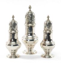 SET OF THREE GEORGE II SILVER CASTERS having pierced lid and spiral knop terminal, circular foot,