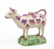 SWANSEA POTTERY PINK LUSTRE COW CREAMER, with cover, standing on grassy base, 18cms (w) Provnance: