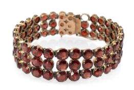ANTIQUE YELLOW METAL BRACELET SET WITH EIGHTY-TWO GRADUATED GARNETS, 20cms long, 33.8gms Provenance: