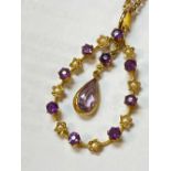 15CT GOLD AMETHYST & SEED PEARL PENDANT, with central drop pear shaped amethyst, on yellow metal