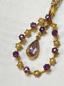 15CT GOLD AMETHYST & SEED PEARL PENDANT, with central drop pear shaped amethyst, on yellow metal