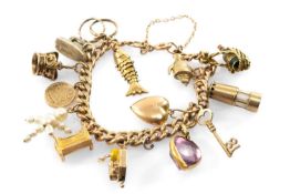 9CT GOLD CHARM BRACELET with fifteen charms, mainly 9ct gold, including fish, miners lamp, '18' key,