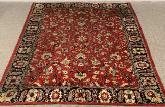 EASTERN STYLE RED & BLACK GROUND TRADITIONAL STYLE RUG all over opposing floral central pattern,